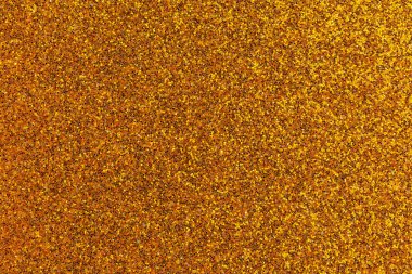 Bir sürü küçük altın ve siyah noktalı altın ve siyah bir zemin. Arka plan çok parlak ve noktalar çok küçük.