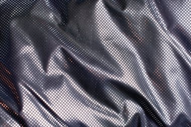 Soyut bir arkaplan olarak seçici odak ile gümüş kaplama ısı yansıtıcı ceket.