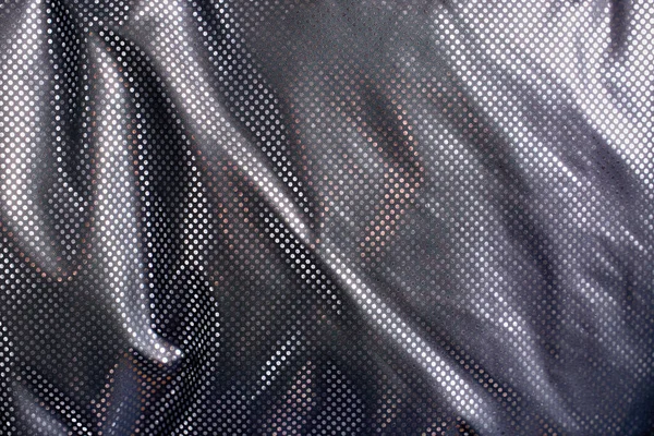 Soyut bir arkaplan olarak seçici odak ile gümüş kaplama ısı yansıtıcı ceket.