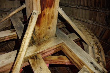 Yel değirmeninin içindeki eski ahşap teçhizat mekanizmasının detaylı kereste yapısı ile yakın plan görüntüsü..