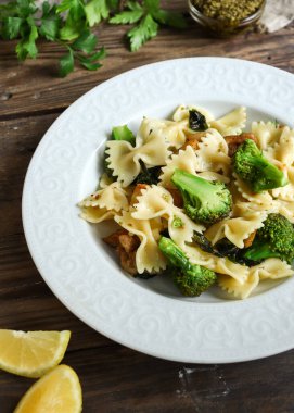 Brokoli, tavuk ve fesleğenli Farfalle. İtalyan yemeği. Üst Manzara. Ahşap arka plan. Boşluğu kopyala.