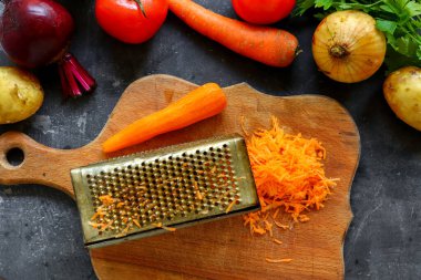 Adım adım sebze çorbası ya da sebze çorbası pişiriyorum. Sebze dilimleme, rendelenmiş havuç. Malzemeler. Üst görünüm.