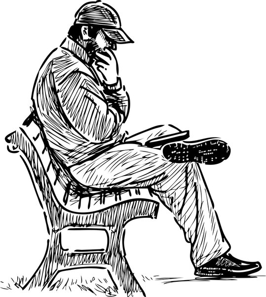 man reading on a park bench.