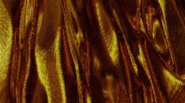 Düz olmayan çizgileri olan güzel altın soyutlama. Sarı ve kahverengi renkli küçük kabarcıklardan oluşan bir doku. Kırışmış altın kumaş..