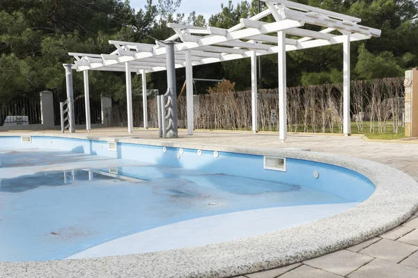 empty swimming pool without water in hotel, renovation process, preparing for new touristic season