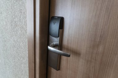Closed door in hotel with electronic key lock. Digital security protection.