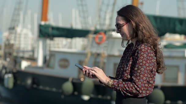 Young Woman with a Phone in Yacht Club — Stock Video