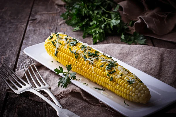 Boiled corn with parmesan and parsley — Stock Photo, Image