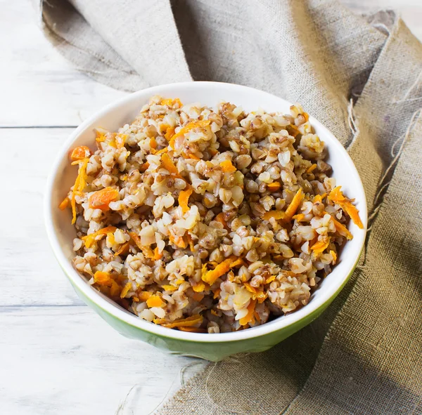 Buckwheat with carrots in light background — Stock Photo, Image