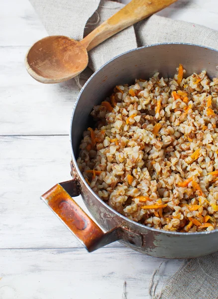 Buckwheat with carrots in light background — Stock Photo, Image