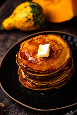 Pumpkin pancakes with maple syrup. Autumn food