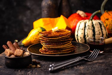 Pumpkin pancakes with maple syrup. Autumn food