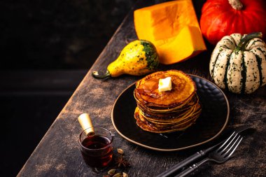 Pumpkin pancakes with maple syrup. Autumn food