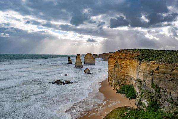 Auringonsäteet Loistavat Myrskyisissä Pilvissä Kahdentoista Apostolin Kalliomuodostelmissa Great Ocean Roadilla — kuvapankkivalokuva