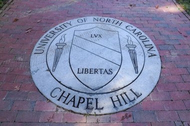 Chapel Hill, NC / USA - October 21, 2020: The University of North Carolina Chapel Hill Seal in brick walk way. clipart