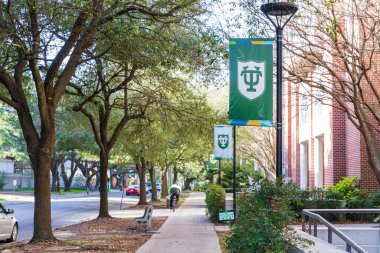 New Orleans, LA - 2021: Sidewalk on campus of Tulane University with logo on banners clipart