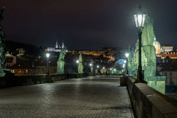 Charles Bridge and lighted lanterns on it and statues