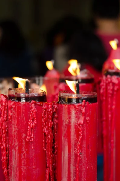 The flame on red candle at the Chinese temple.