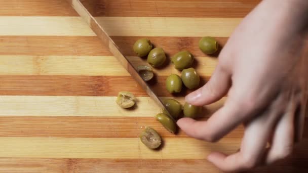 Kadının Elleri Ahşap Kesim Tahtasının Üzerinde Mutfak Bıçağıyla Yeşil Zeytin — Stok video