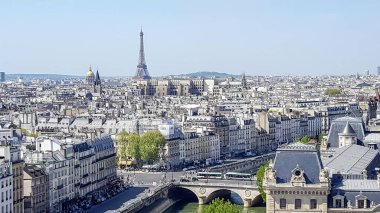 İlkbaharda güzel bir günde Notre Dame Katedrali 'nin tepesinden Paris' e bakın. Eyfel Kulesi arka planda görünür ve Seine nehri şehrin içinden akar..