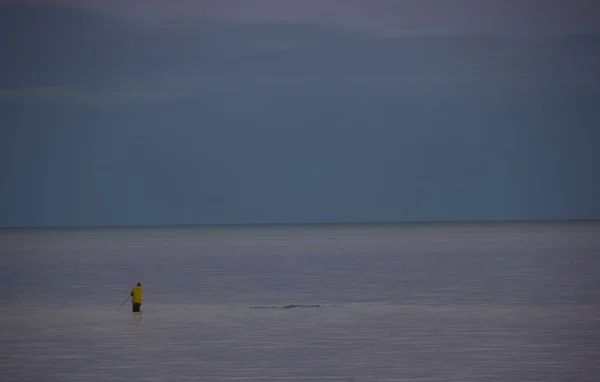 Fisherman on the shore of lake Ladoga — Stock Photo, Image