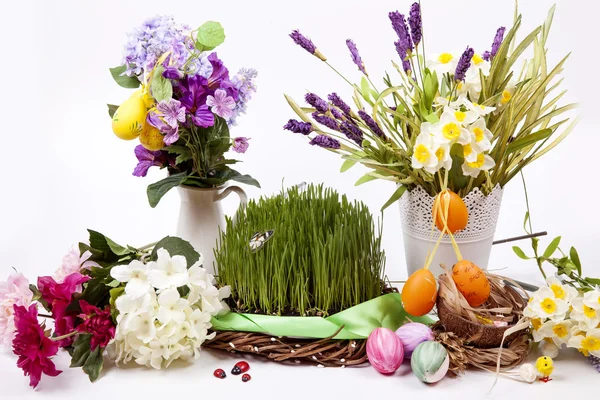 Oeufs et fleurs de Pâques avec de l'herbe sur fond blanc — Photo