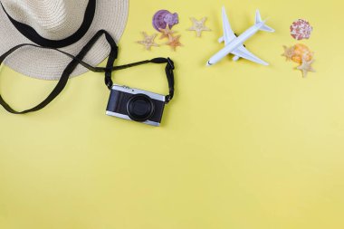 Üst ya da düz kamera, hasır şapka, deniz kabuklu uçak modeli ve sarı arka planda fotokopi alanı olan denizyıldızı. Yaz tatili geçmişi.