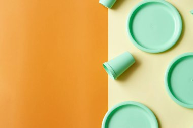 Sarı ve turuncu arka planda plastik kaplar