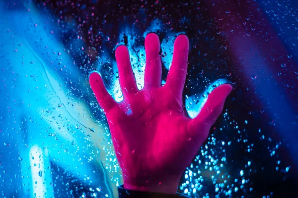 Dramatic Hand Neon Lighted Window Rain Drops Bright Neoned Colors — Stock Photo, Image