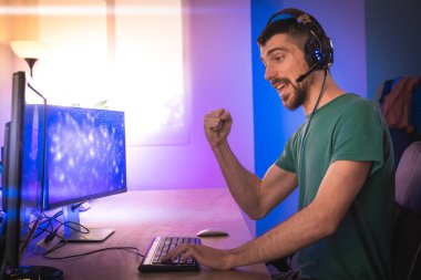 Profesyonel oyuncu kişisel bilgisayarında oyun oynuyor. Retro Arcade Style 'daki Neon Lights' ın aydınlattığı oda. Siber Şampiyonluk. Görüntü Bokeh 'e dönüşür.