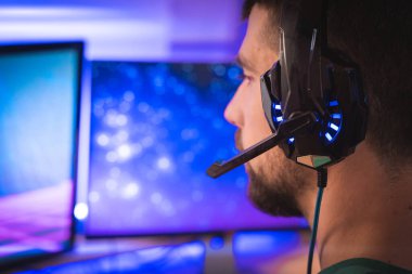 Profesyonel oyuncu kişisel bilgisayarında oyun oynuyor. Retro Arcade Style 'daki Neon Lights' ın aydınlattığı oda. Siber Şampiyonluk. Görüntü Bokeh 'e dönüşür.