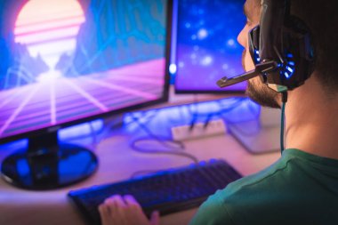 Profesyonel oyuncu kişisel bilgisayarında oyun oynuyor. Retro Arcade Style 'daki Neon Lights' ın aydınlattığı oda. Siber Şampiyonluk. Görüntü Bokeh 'e dönüşür.