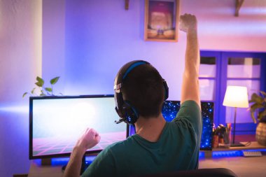 Profesyonel oyuncu kişisel bilgisayarında oyun oynuyor. Retro Arcade Style 'daki Neon Lights' ın aydınlattığı oda. Siber Şampiyonluk. Görüntü Bokeh 'e dönüşür.