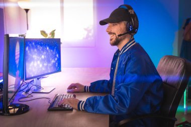 Profesyonel oyuncu kişisel bilgisayarında oyun oynuyor. Retro Arcade Style 'daki Neon Lights' ın aydınlattığı oda. Siber Şampiyonluk. Görüntü Bokeh 'e dönüşür.