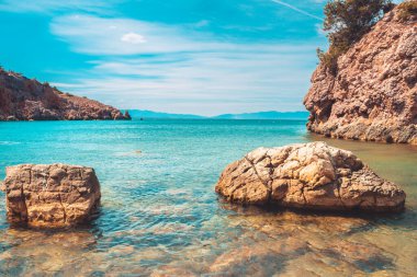 Güzel kayalık kıyı manzarası ve harika kristal mavi okyanus. Akdeniz 'in sarp kayalıklı turkuaz suyu.