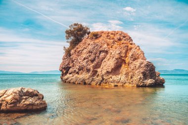 Güzel kayalık kıyı manzarası ve harika kristal mavi okyanus. Akdeniz 'in sarp kayalıklı turkuaz suyu.