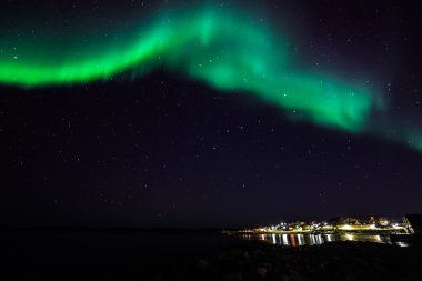 Northern lights over old harbor of Nuuk city clipart