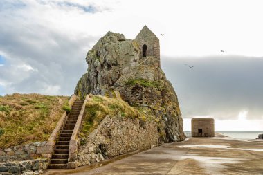 Saint Helier hermitage site with medieval chapel on top with german ww2 bunker in the background, bailiwick of Jersey, Channel Islands clipart