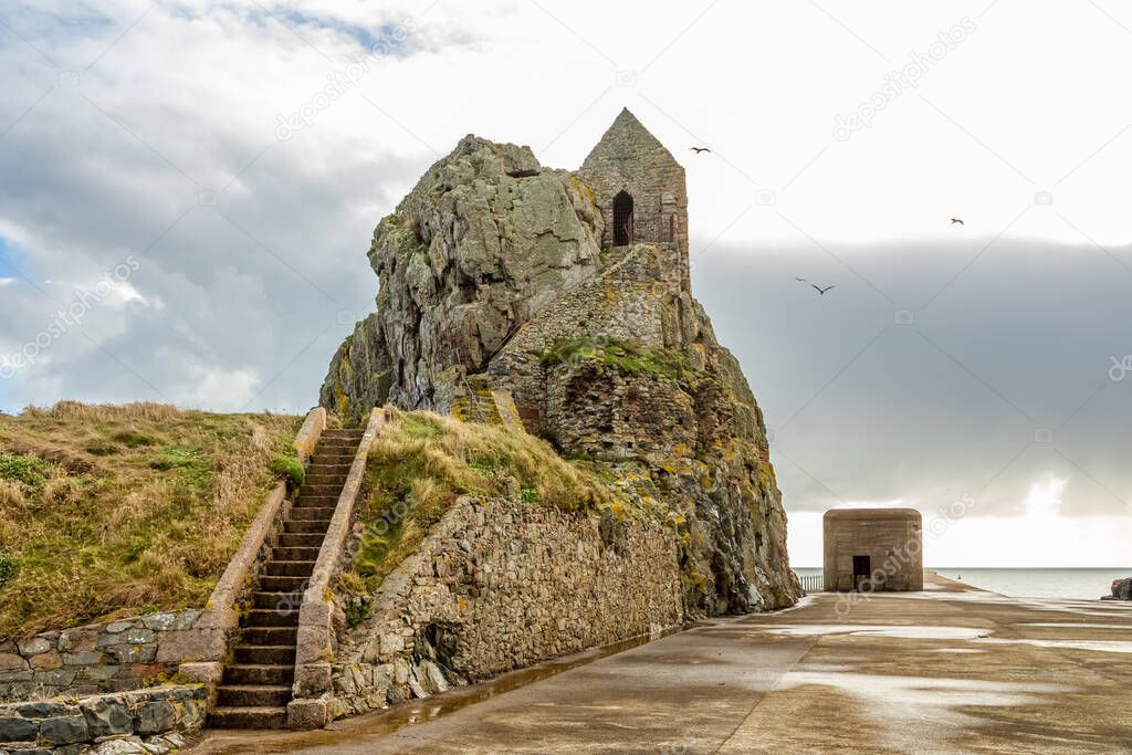Saint Helier hermitage site with medieval chapel on top with german ww2 bunker in the background, bailiwick of Jersey, Channel Islands