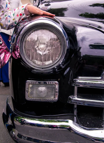 Retro car festival. Retro car headlight. Fragment of the front of a retro car.