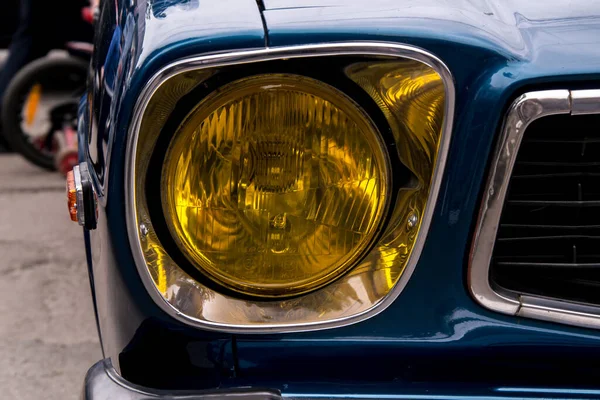 Retro car festival. Retro car headlight. Fragment of the front of a retro car.