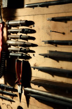 Workbench with hand tools on a wooden base. Garage workstation for classic car repair. Father's Day concept. Workspace organization.