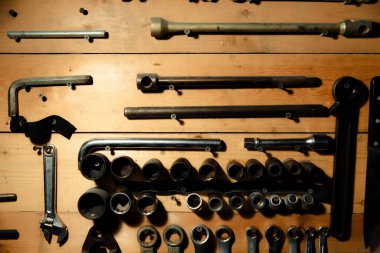 Workbench with hand tools on a wooden base. Garage workstation for classic car repair. Father's Day concept. Workspace organization.