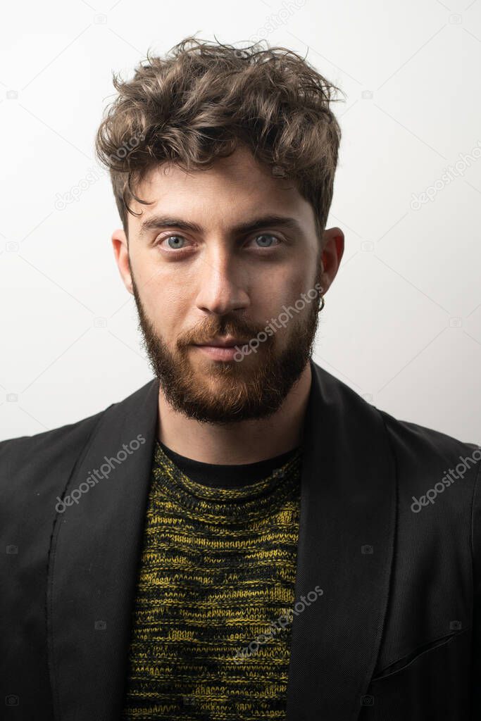 Young bearded man headshot. Portrait of a guy with Rembrandt light.