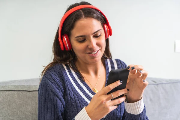 Young Woman Listening Music Red Wireless Headphones Mobile Smart Phone — Stock Photo, Image