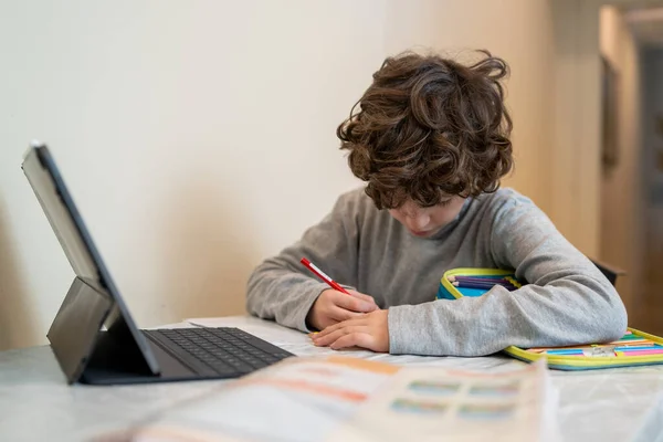 Schoolboy Studying Kitchen Table Watching Lessons Remotely Online Writing Paper — Stock Photo, Image