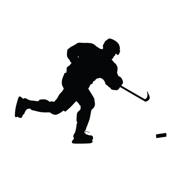 Silhouette vettoriale giocatore di hockey su ghiaccio. Giocatore di hockey spara il pu — Vettoriale Stock
