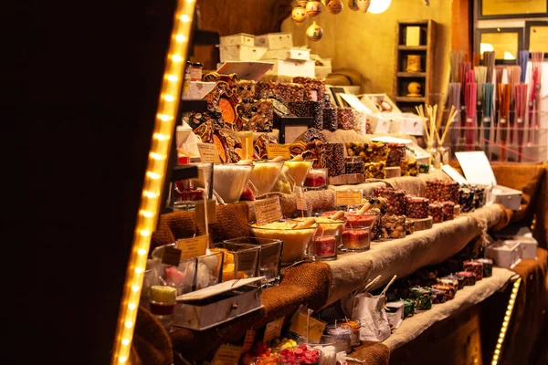 market stall showing an assortment of handmade candles from spices at traditional famous christmas market (christkindlmarkt) at Merano, South Tyrol/Italy (Meran, Suedtirol)