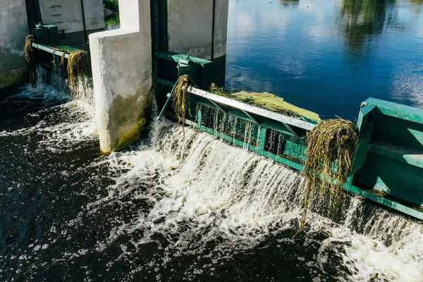 Water dam on a river. Water level regulation. Environment industry background. Summer draught low water level.