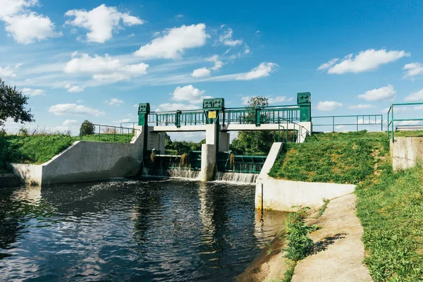 Water dam on a river. Water level regulation. Environment industry background. Summer draught low water level.